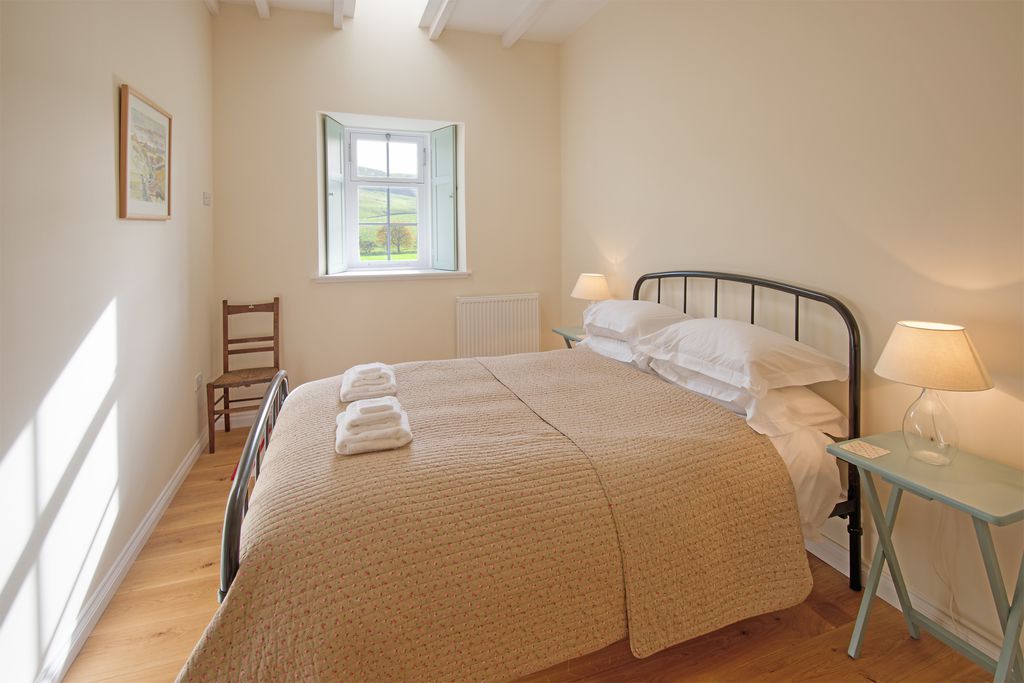 Light and airy double bedroom with a shuttered window looking out onto the beautiful countryside