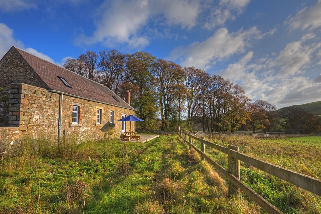 Beautiful view of the outside of the cottage with outside seating area