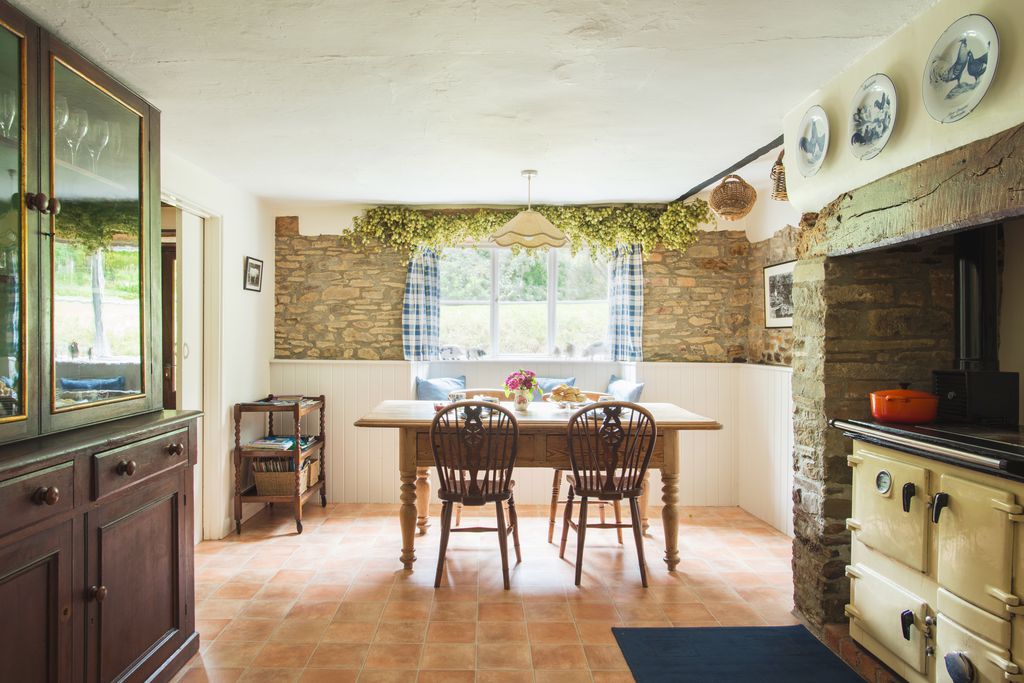 The dining room at the mill with light streaming through the window onto the dining table