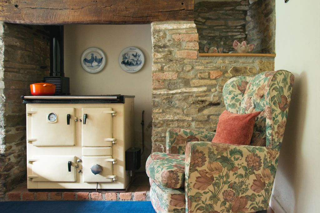 A cosy armchair sat in the warmth of the kitchen aga