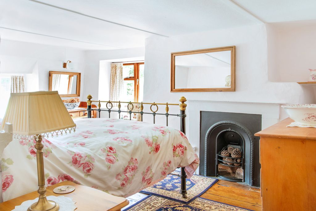 Cosy double bedroom with armchair by the window