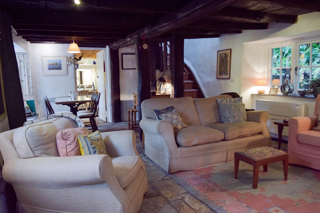 Sitting room with cosy sofas at Stares Nest Cottage in Devon