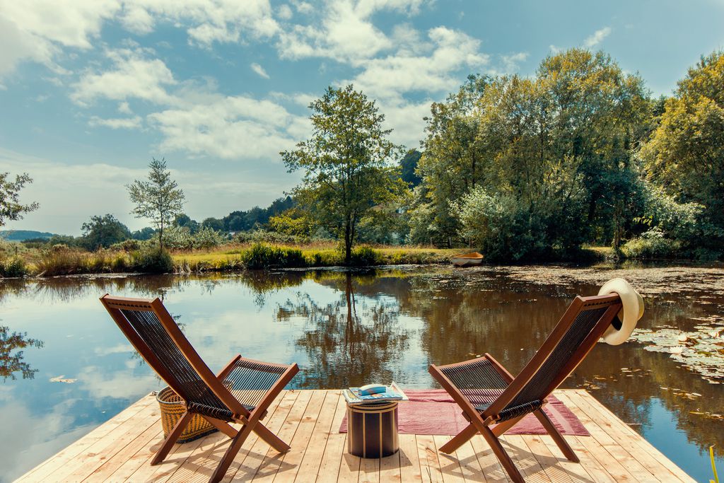 Deckchairs on the pontoon overlooking the lake at The Wellhouse & Wellhayes Barn in Dorset