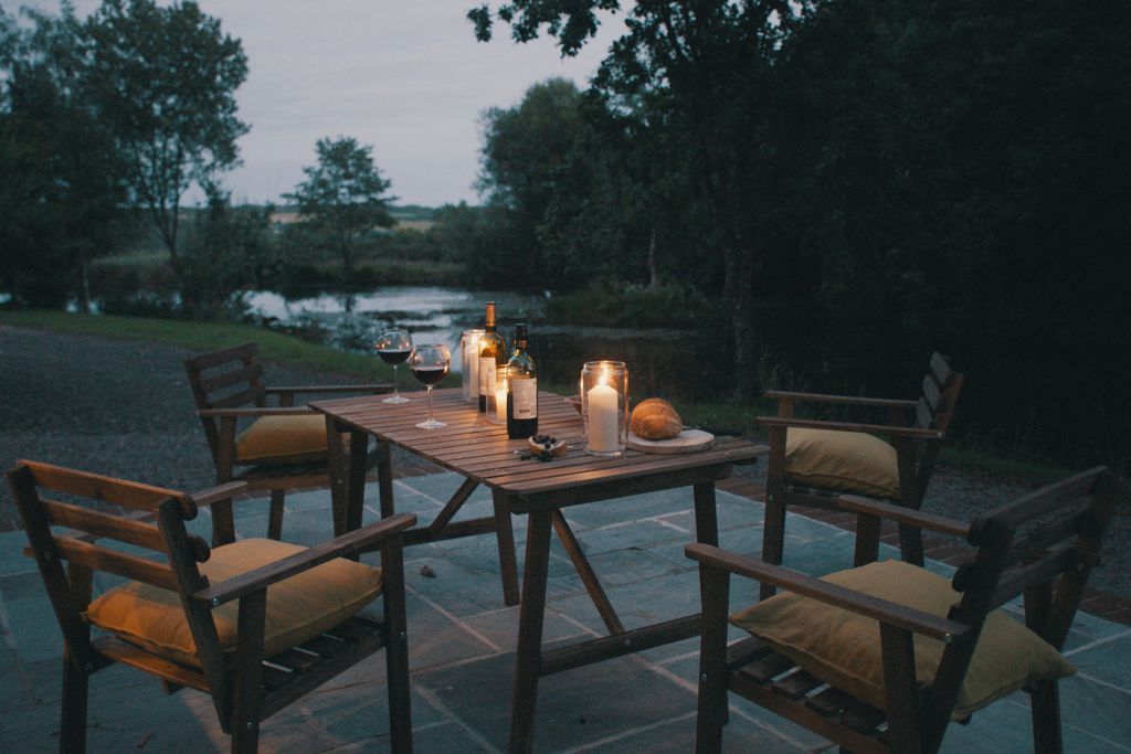 Outside seating area at night with candles lit on the table