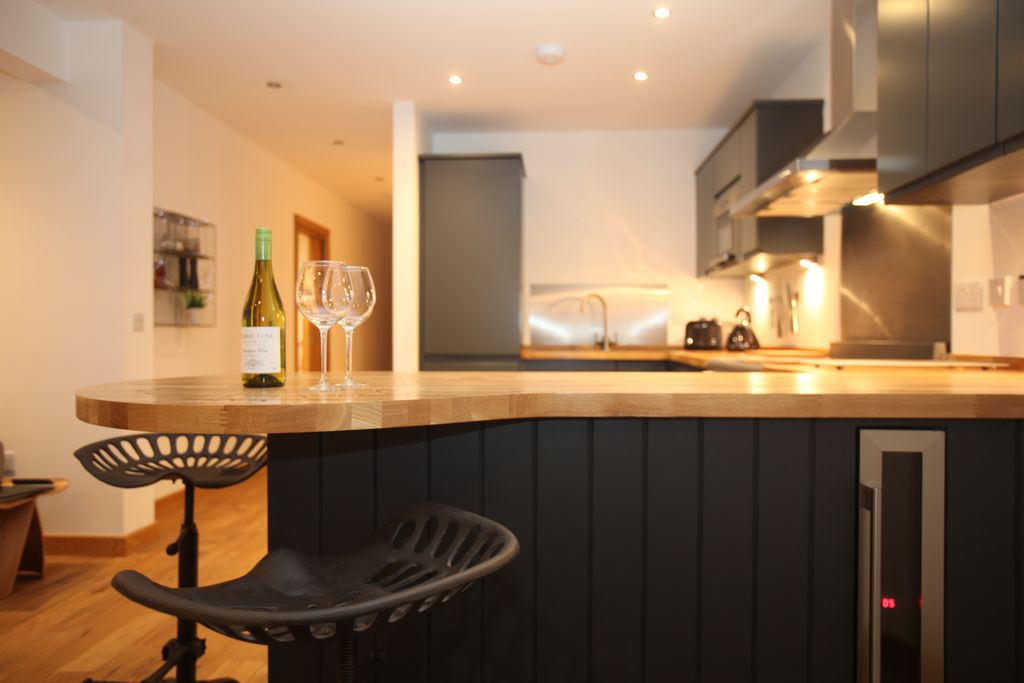 sleek modern kitchen with wine glasses on the worktop