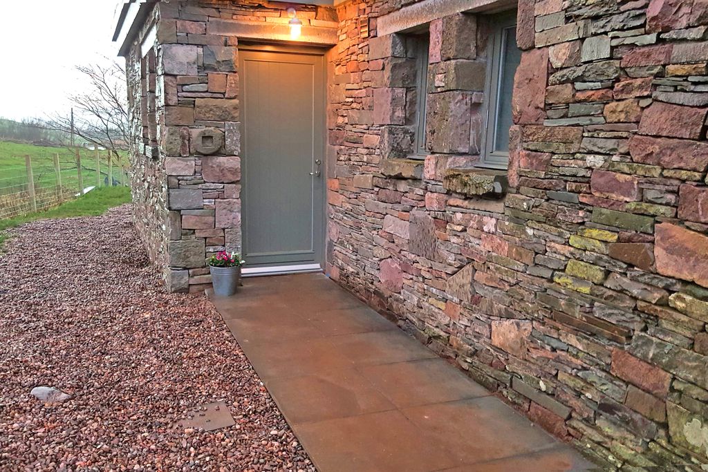 Entrance to the property with traditional stone walls