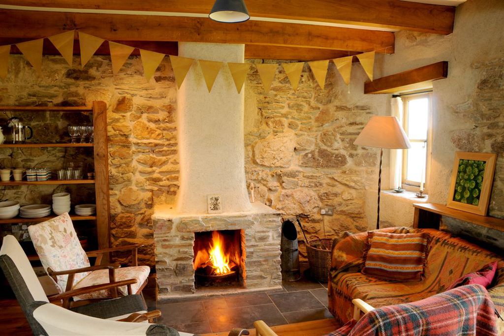 Warm and cosy sitting room with an open fire 