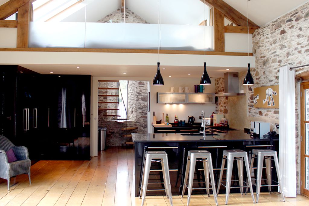 Modern open plan kitchen with stairs leading to a bedroom 