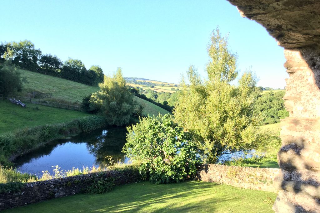 View of the lake from the barn with country side in the distance