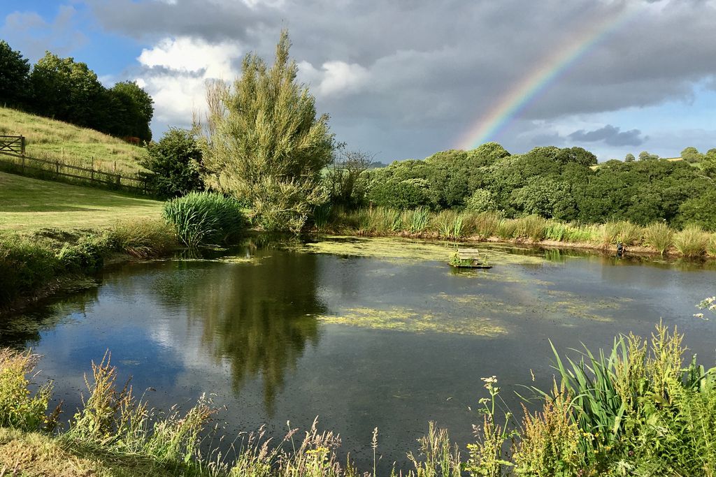 Country side lake view with rainbow in the background 