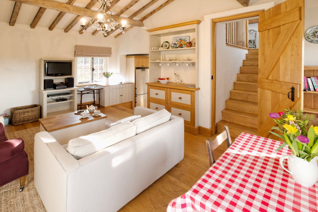 The clean and bright kitchen/lounge at The Cottage at Collfryn Farm in Powys, Wales