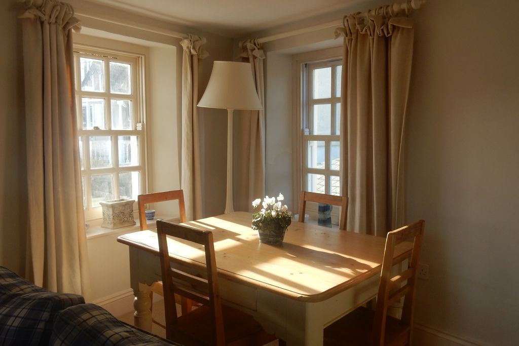 Sun shining through the sitting room window onto the Dining table