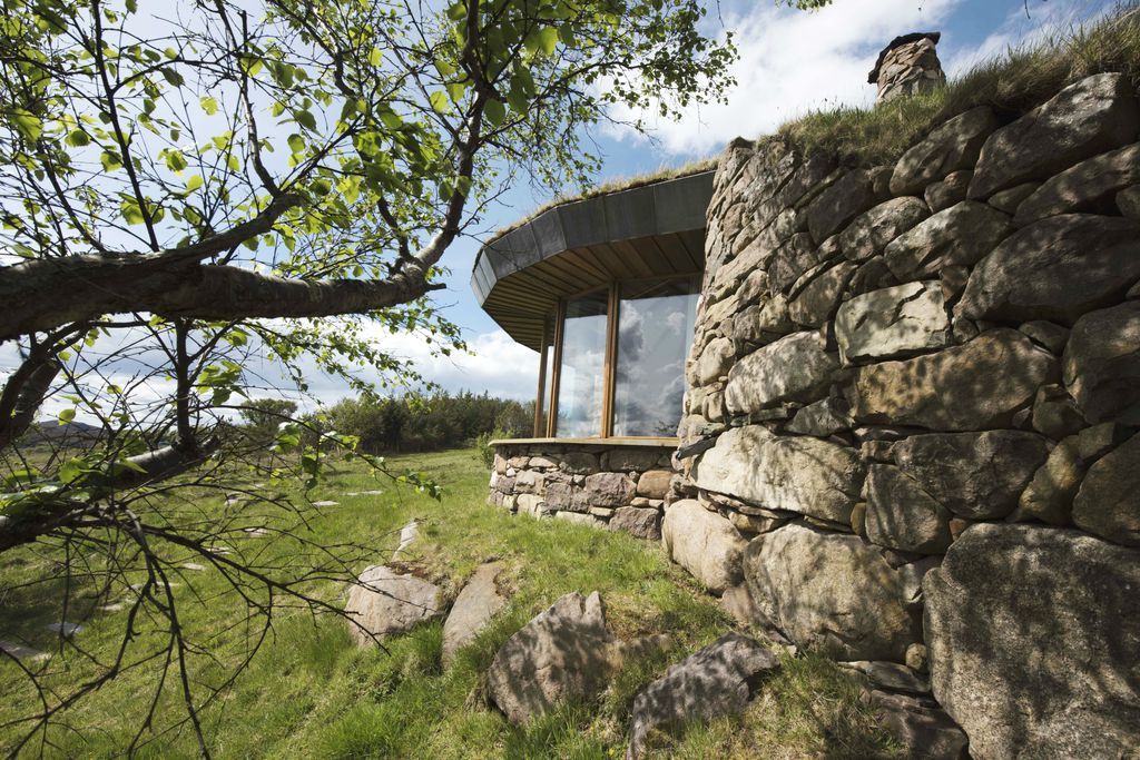 Exterior of Gille Buidhe's Broch in Highland, Scotland surrounded by beautiful mountainous landscape