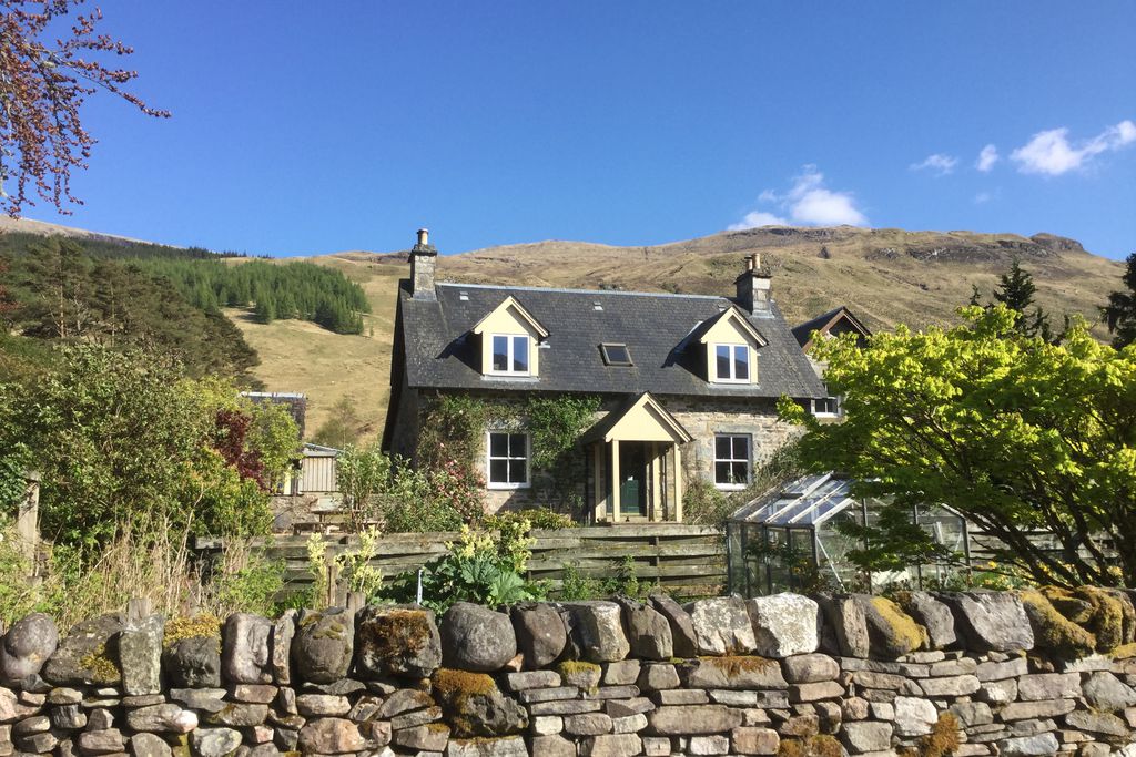 The Old House Scotland exterior of the house nestled into the rolling hills