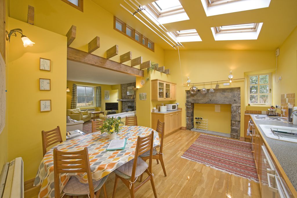 Large open plan kitchen with a family size dining table leading on the living room