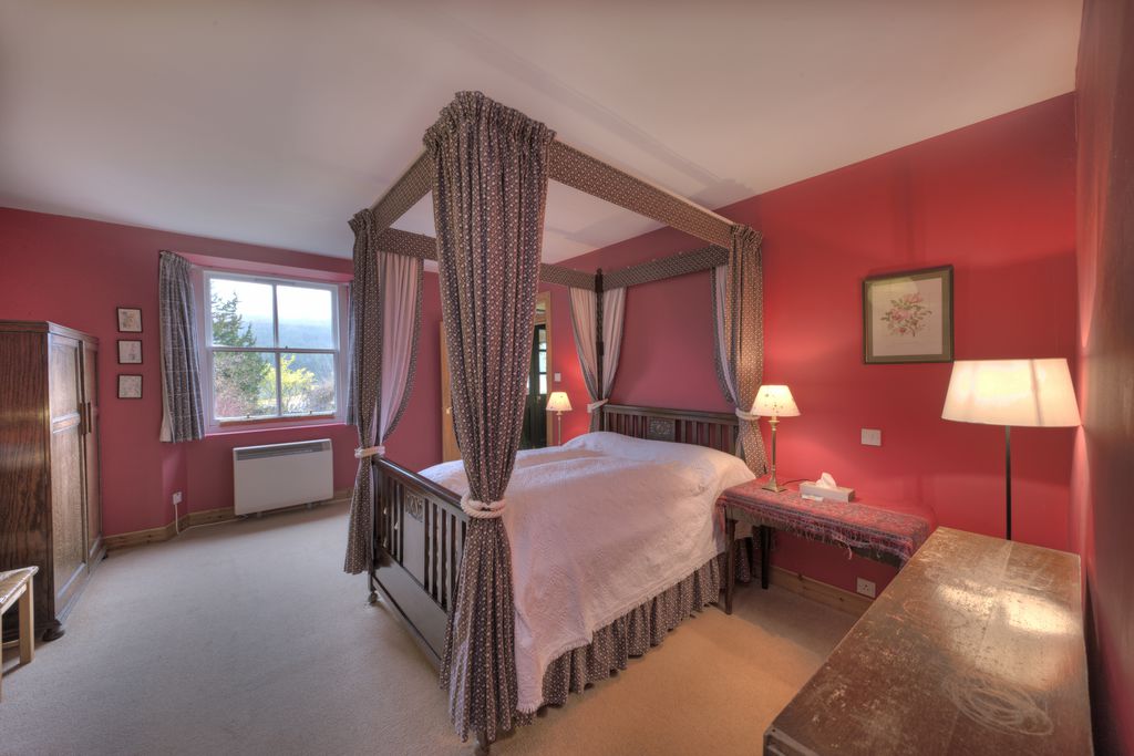 Large double bedroom with four poster bed