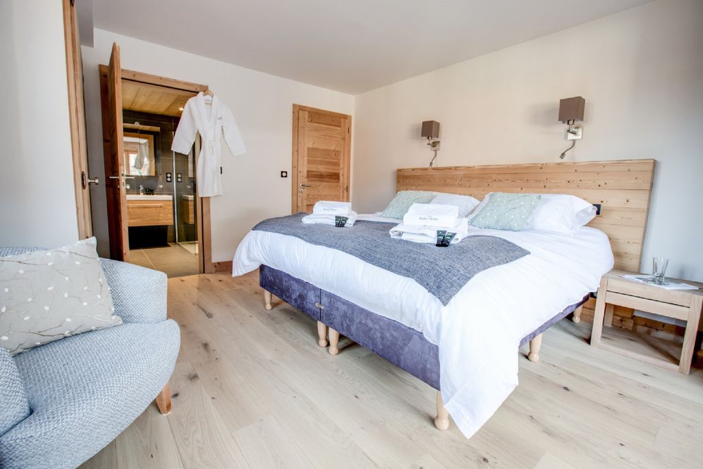 Modern bedroom with fluffy, complimentary robes in Les Roches Noires in Morzine, France 