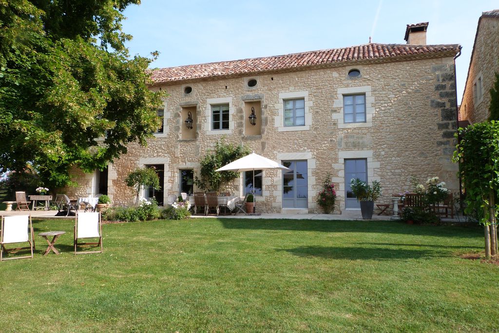 Exterior of Manoir de Beauregard in Dordogne, France with beautiful garden for relaxing and eating al fresco