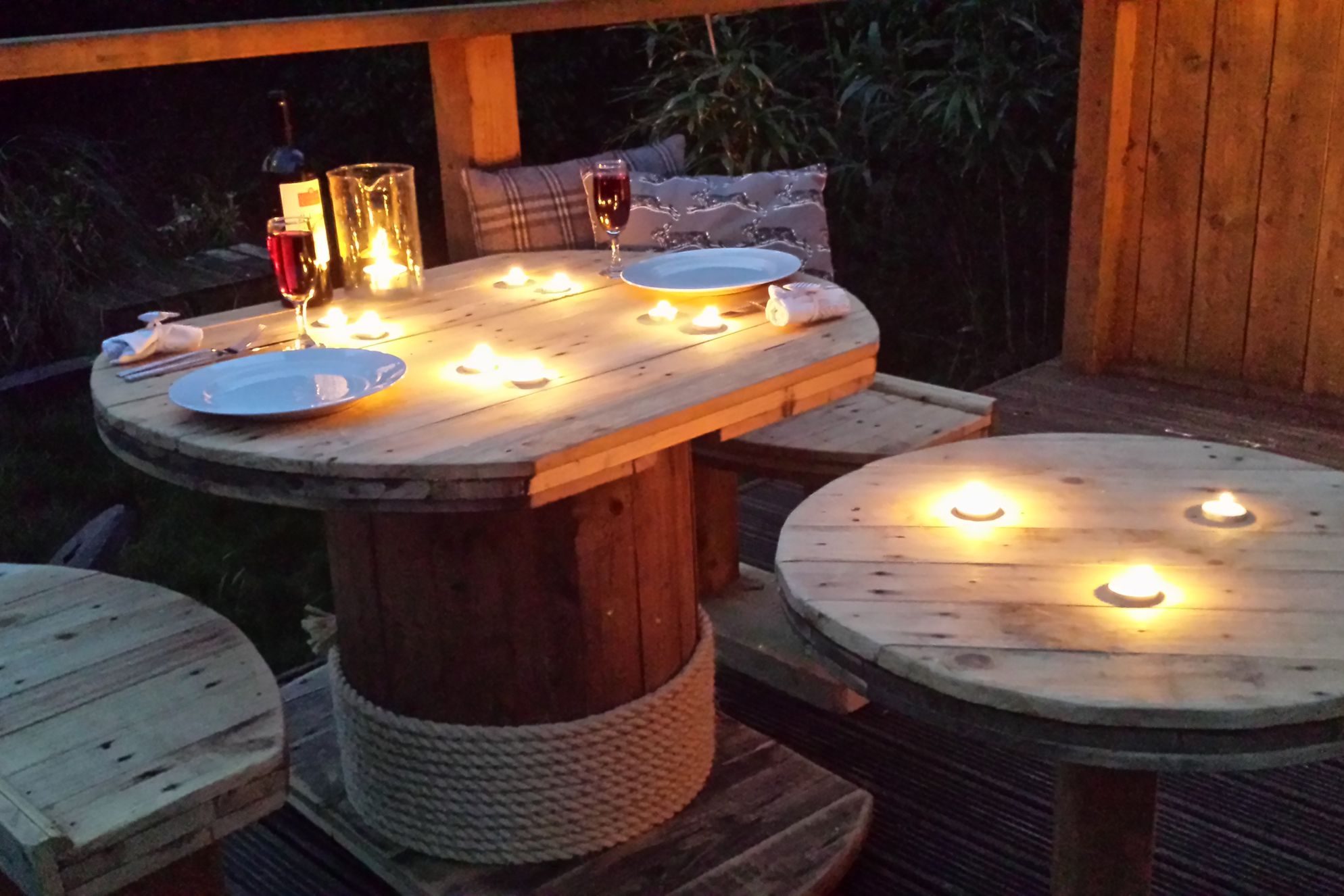 Outside seating area set for dinner with tea lights