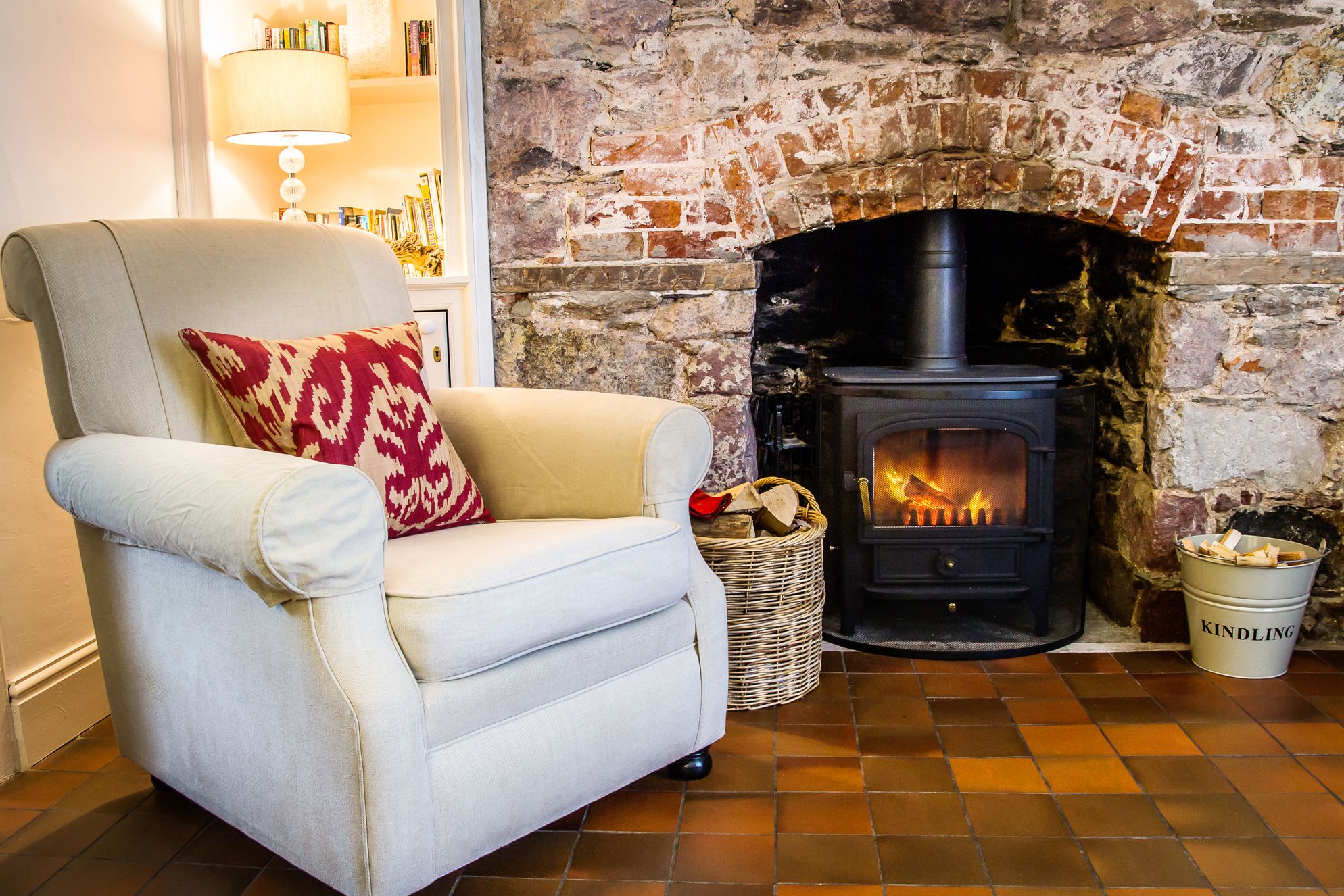 Comfy armchair next to log burner