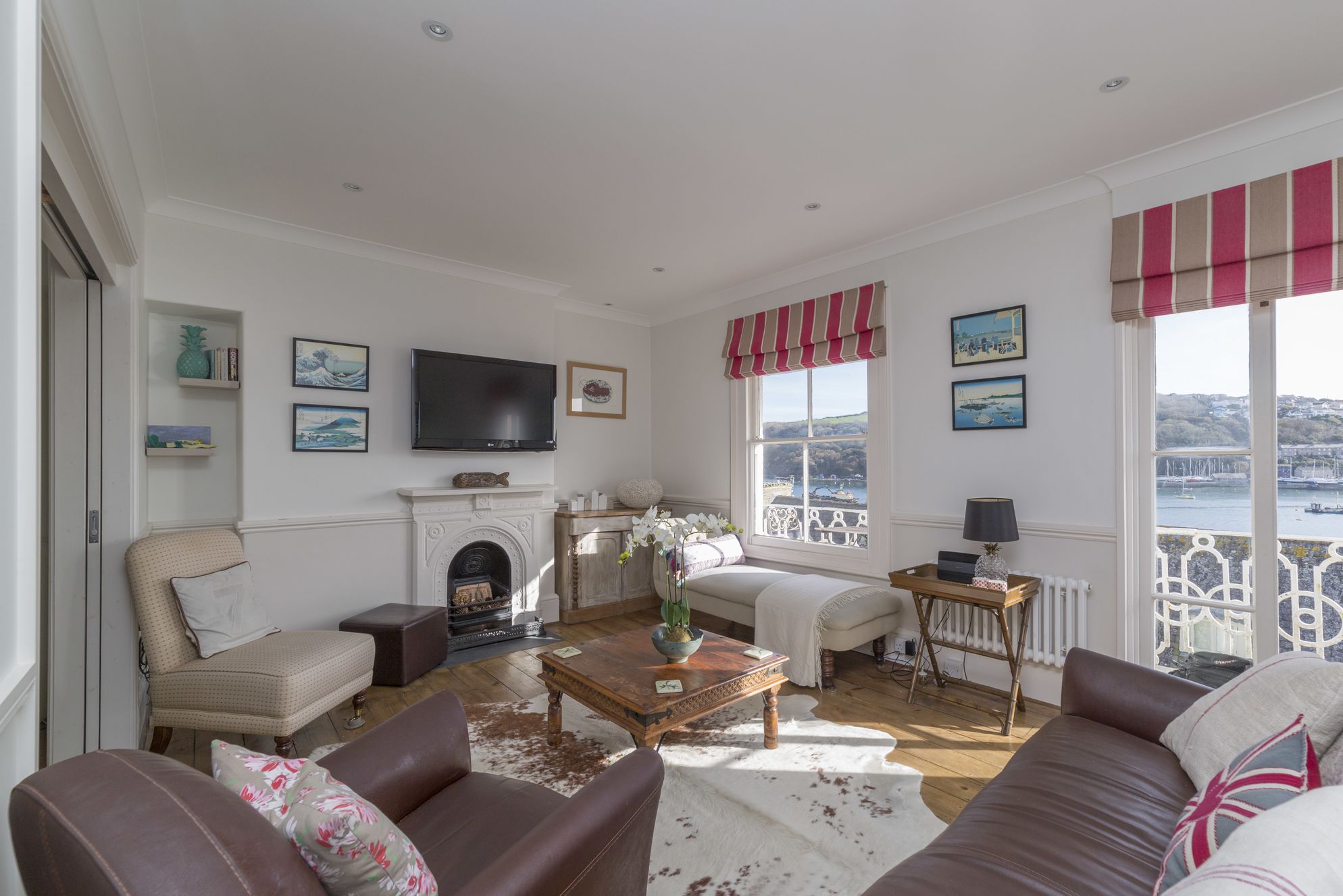 Large airy living room with balcony and view of Fowey harbour