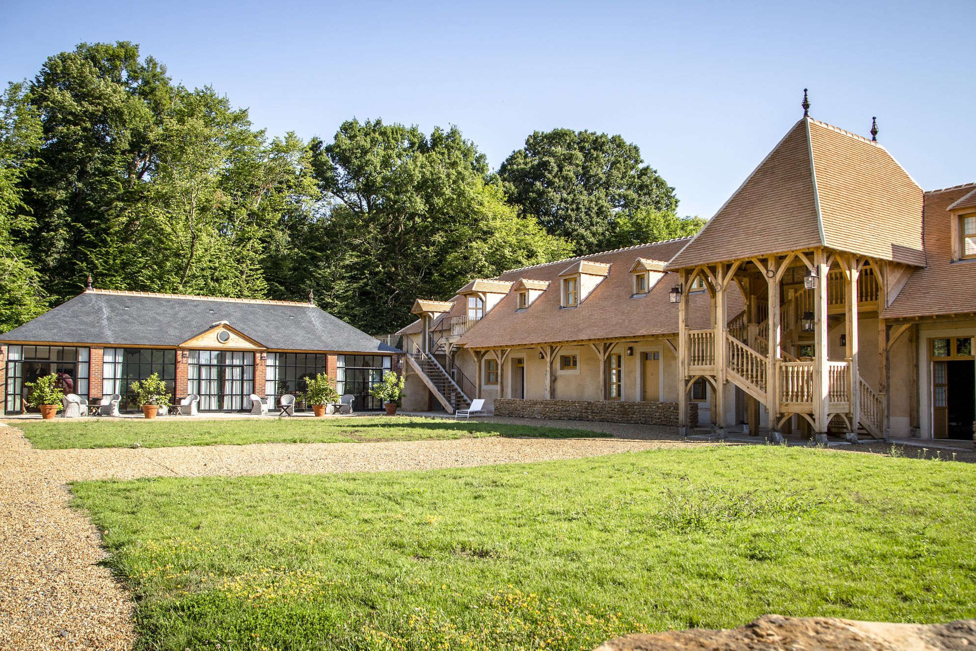 Exterior of the grand Chateau de la Groirie in Western Loire, France with large garden and outdoor seating areas
