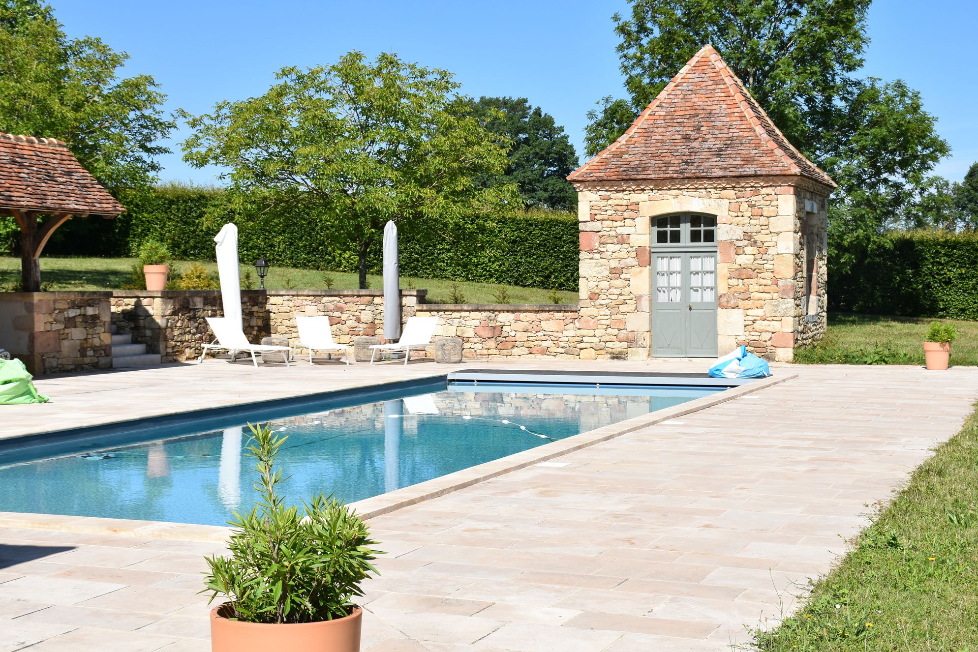 Outdoor swimming pool with loungers at La Rochette in Nailhac, Dordogne, France