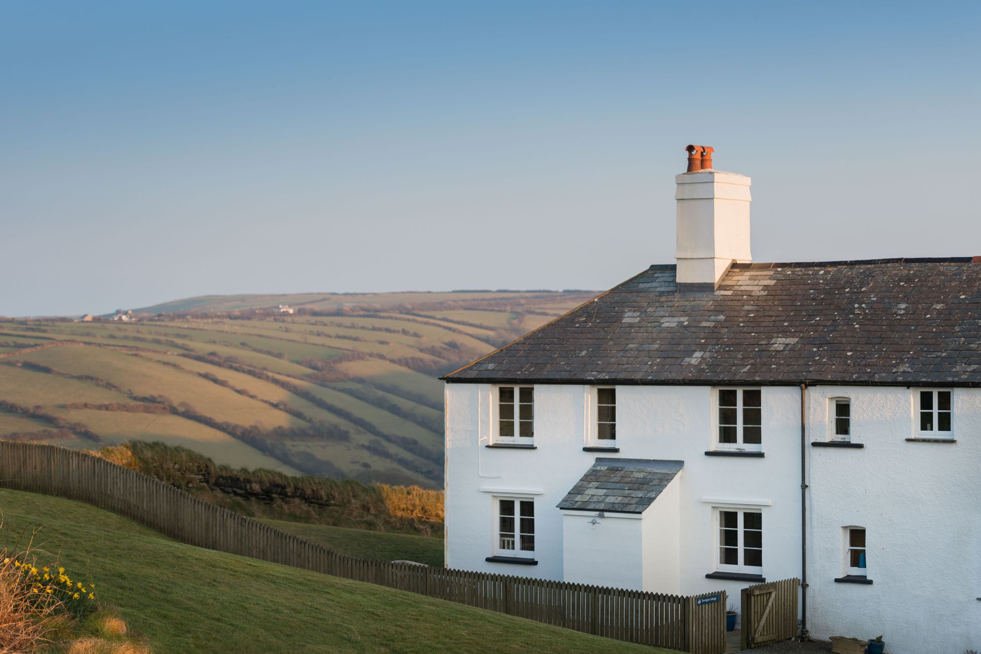 Exterior of Trevigue cottage in the sunset 