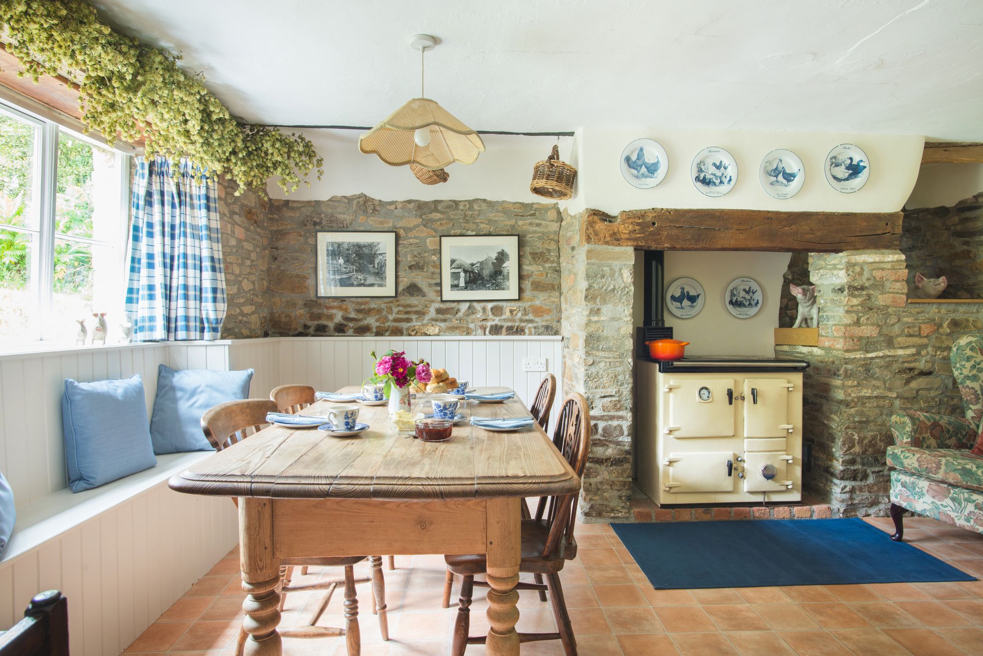 The open plan kitchen and dining room at Horry Mill in Devon with an aga and farmhouse table 