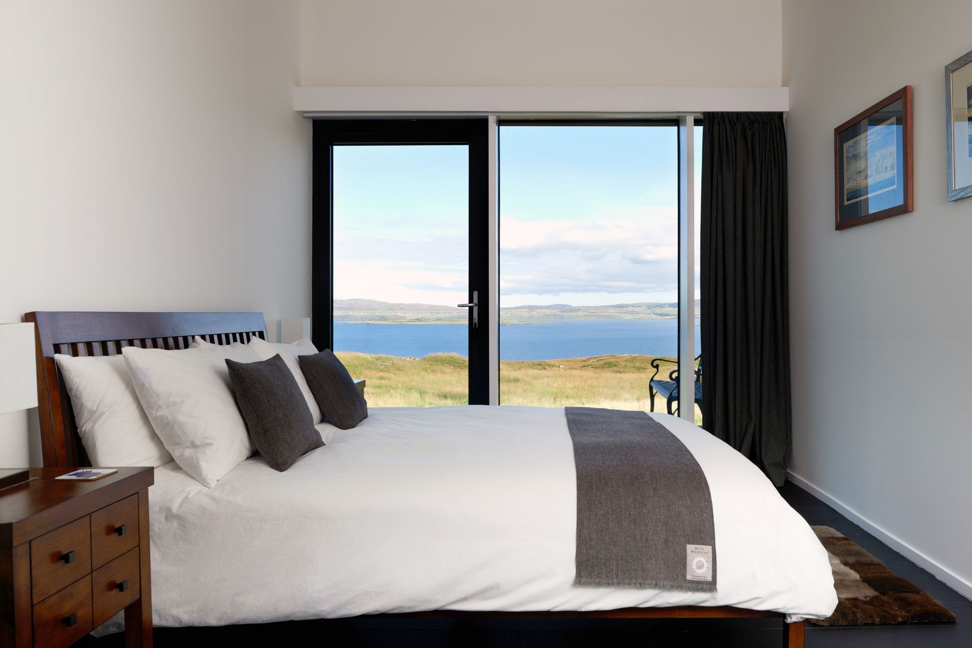 Modern double bedroom with views out to sea