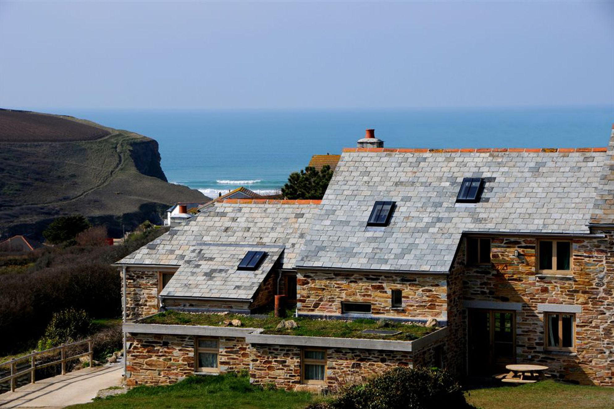 Exterior of Porth Farm Cottages in Devon looking out to sea