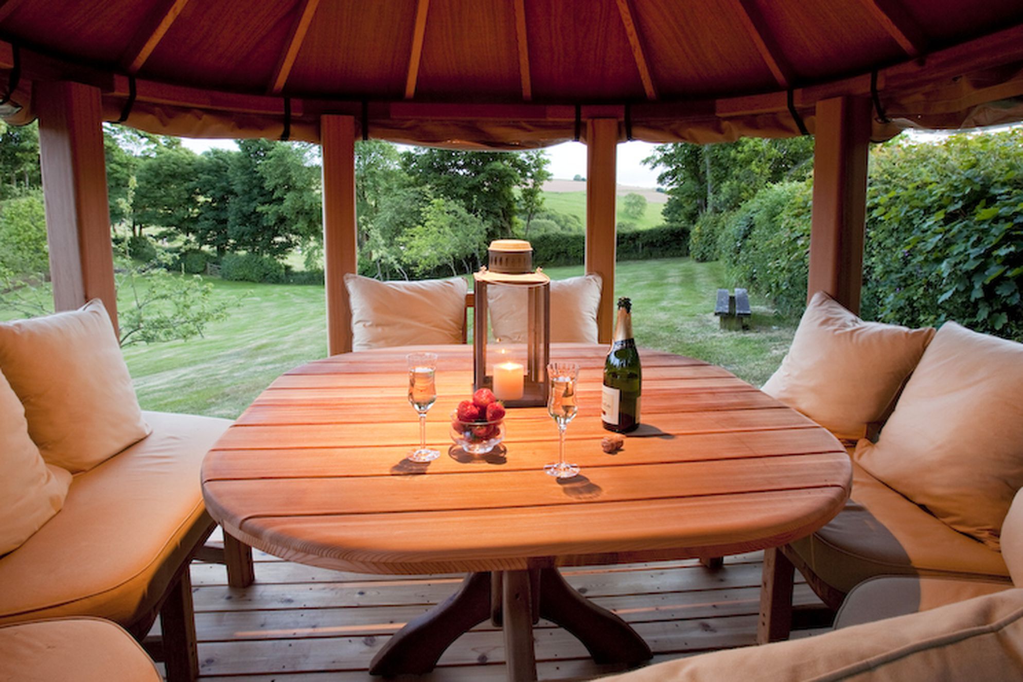 Champagne and strawberries in the garden at Cider Barn