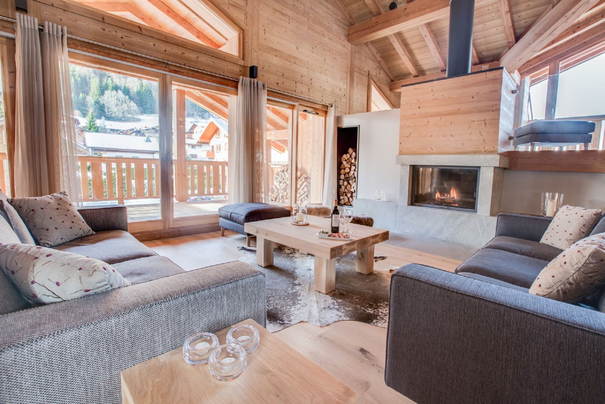 Contemporary living room with cosy woodburner inside Les Roches Noires in Morzine, Savoie 